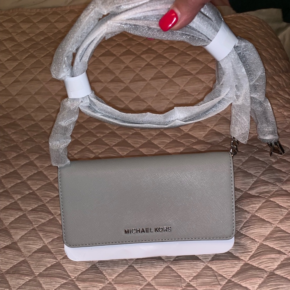 A brand new Michael Kors jetset cross body in gray